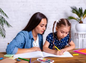 happy-family-mother-daughter-together-draw-with-markers-woman-helps-child-girl-min